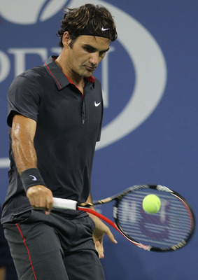 Federer making backhand contact with the ball